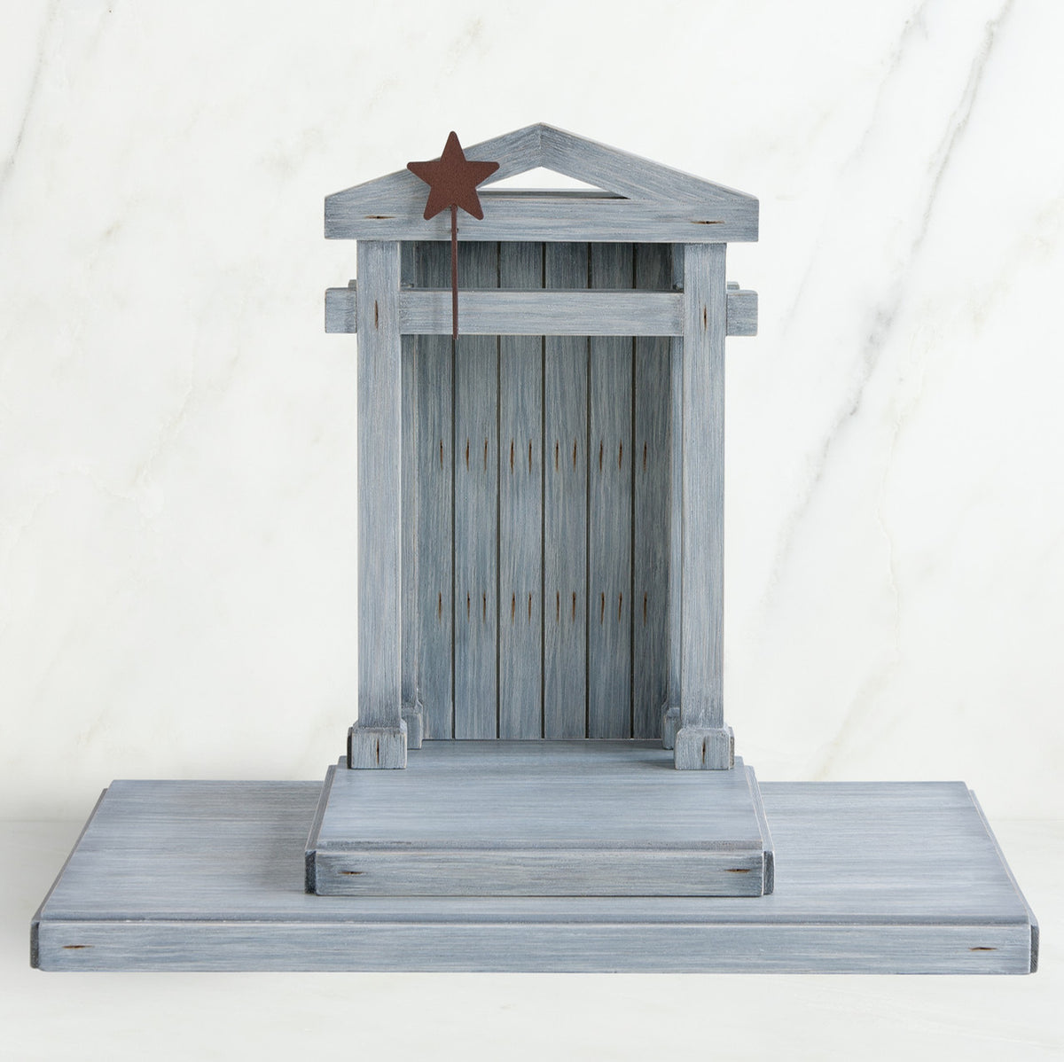 Grey wooden barn figurine open - brown star standing on it